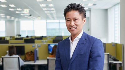 Man in a Corporate Suit Smiling Inside the Office